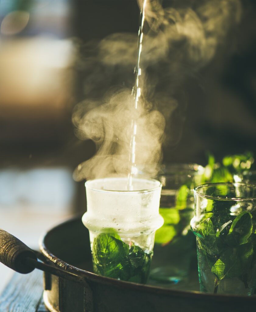 Fresh mint Moroccan tea with herb leaves in glasses